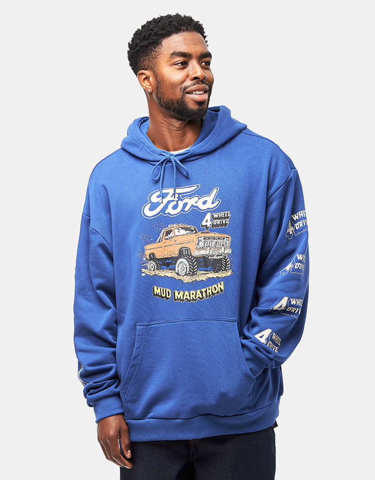 Man wearing a blue hoodie with Ford graphic on a light gray background